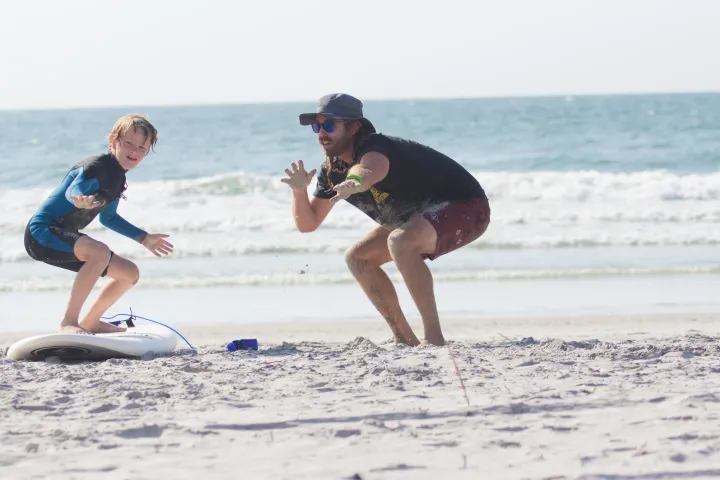 a person riding a surf board on a beach